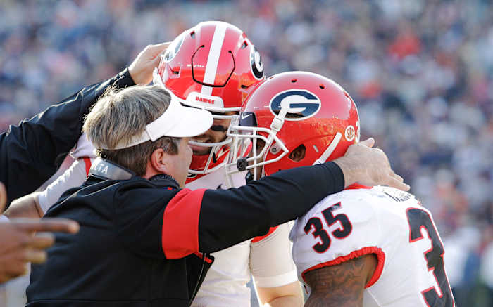 Georgia Bulldogs head coach Kirby Smart celebrates with quarterback Jake Fromm (11) and tailback Brian Herrien (35) after a Bulldogs touchdown against the Auburn Tigers during the first quarter at Jordan-Hare Stadium. Mandatory Credit: John Reed-USA TODAY Sports